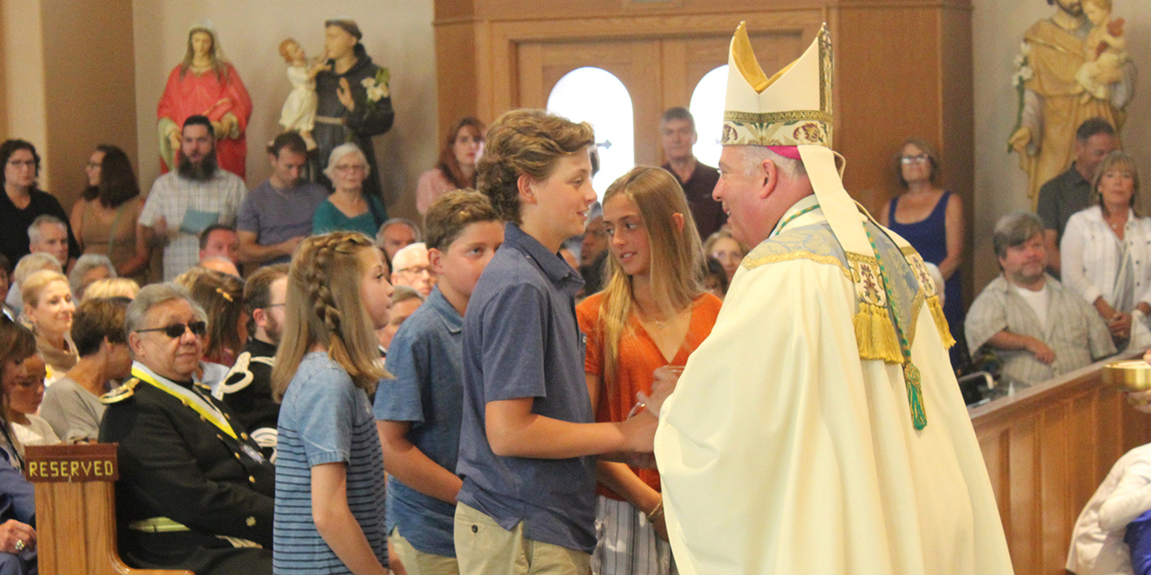 Faithful jam Holy Rosary Church for Mass as the feast of the Assumption celebration begins